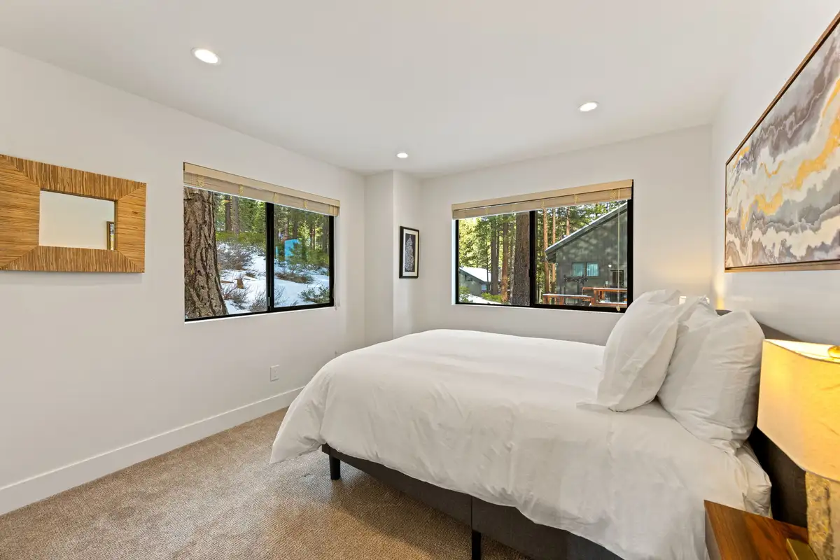 Bedroom with a bed and two windows facing trees, Incline Lakehouse Lookout