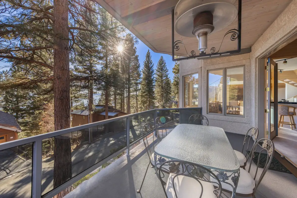 Covered balcony with dining table and patio heater, 90s Tahoe Time Capsule
