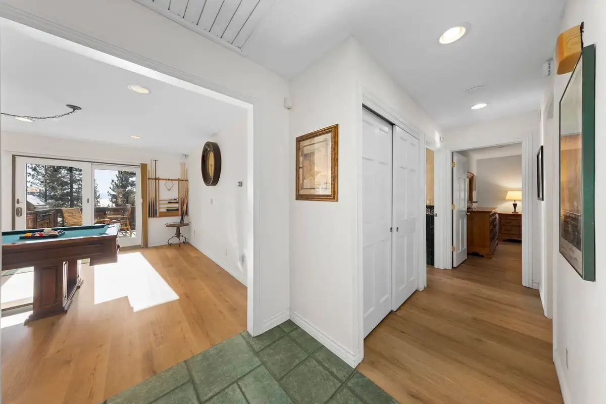 Hallway with closets leading to a room with a pool table, Tranquil Alpine Bliss