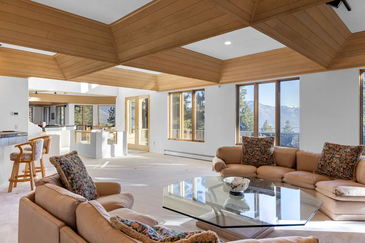 Living room with tan sectional and glass coffee table, 90s Tahoe Time Capsule