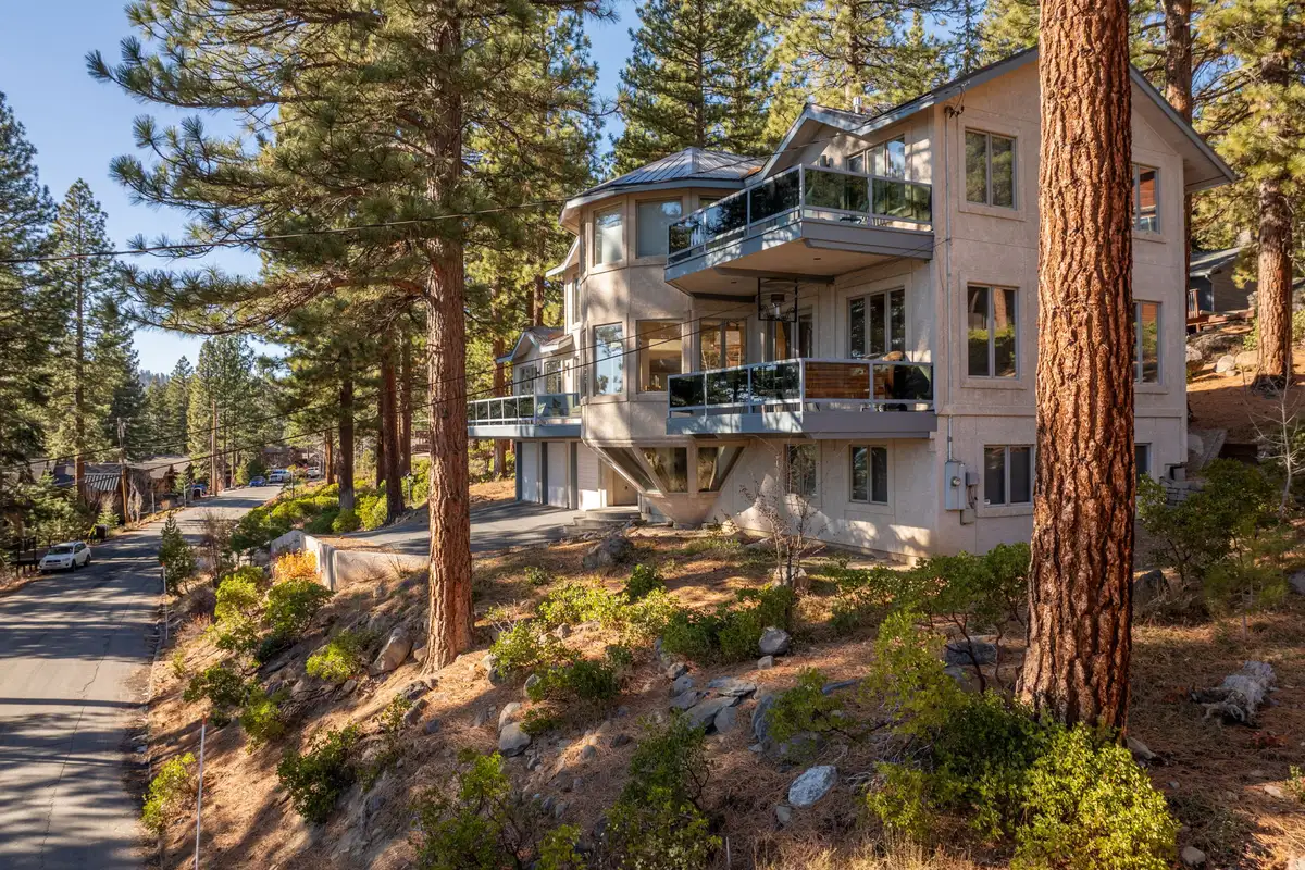 Three-story home with balconies among tall pines, 90s Tahoe Time Capsule